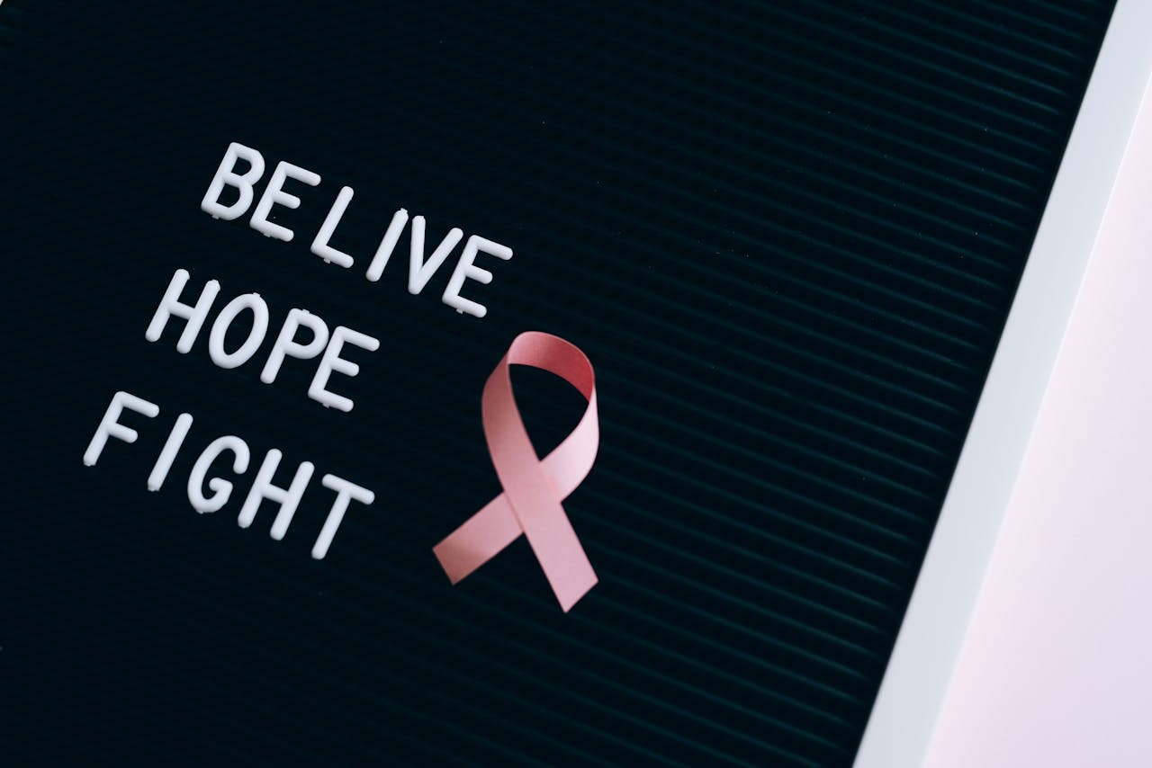 home-hero Inspirational breast cancer awareness message on a letter board with a pink ribbon.