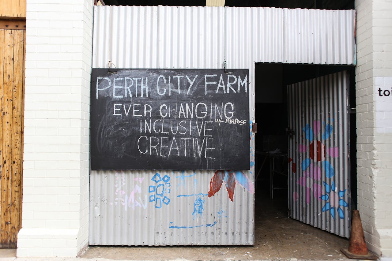 services-05 Chalkboard sign at the entrance of Perth City Farm, showcasing inclusivity and creativity.